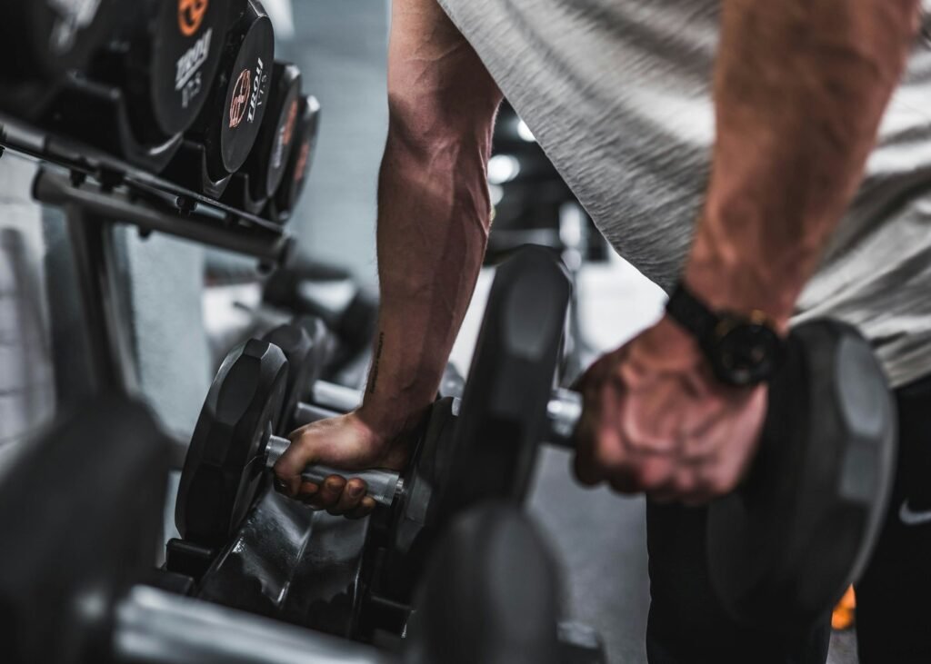 Lifter pulling a heavy dumbbell off a rack
