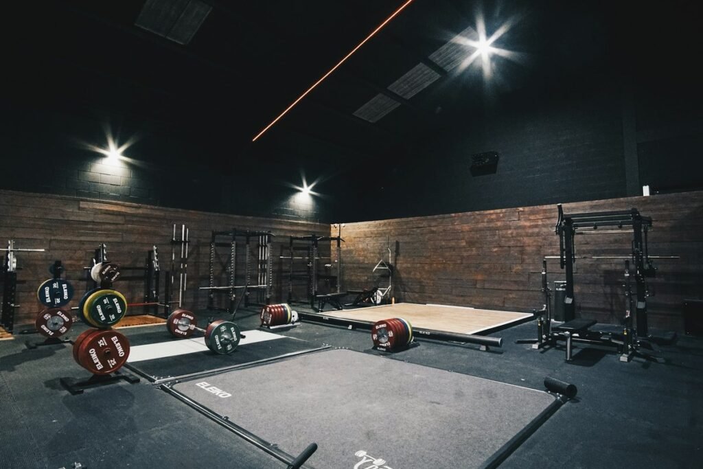 Garage gym with racks, benches, and rubber flooring