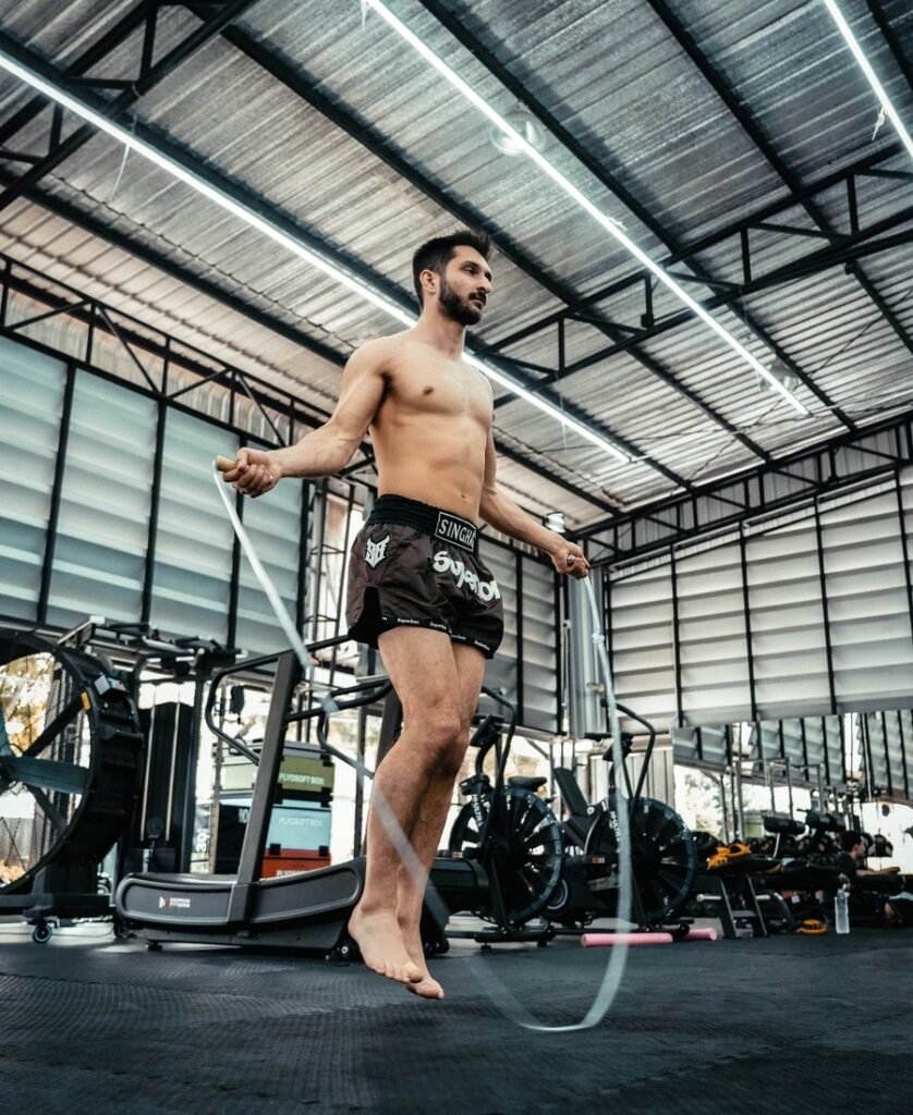 Athlete jumping rope in a dark gym
