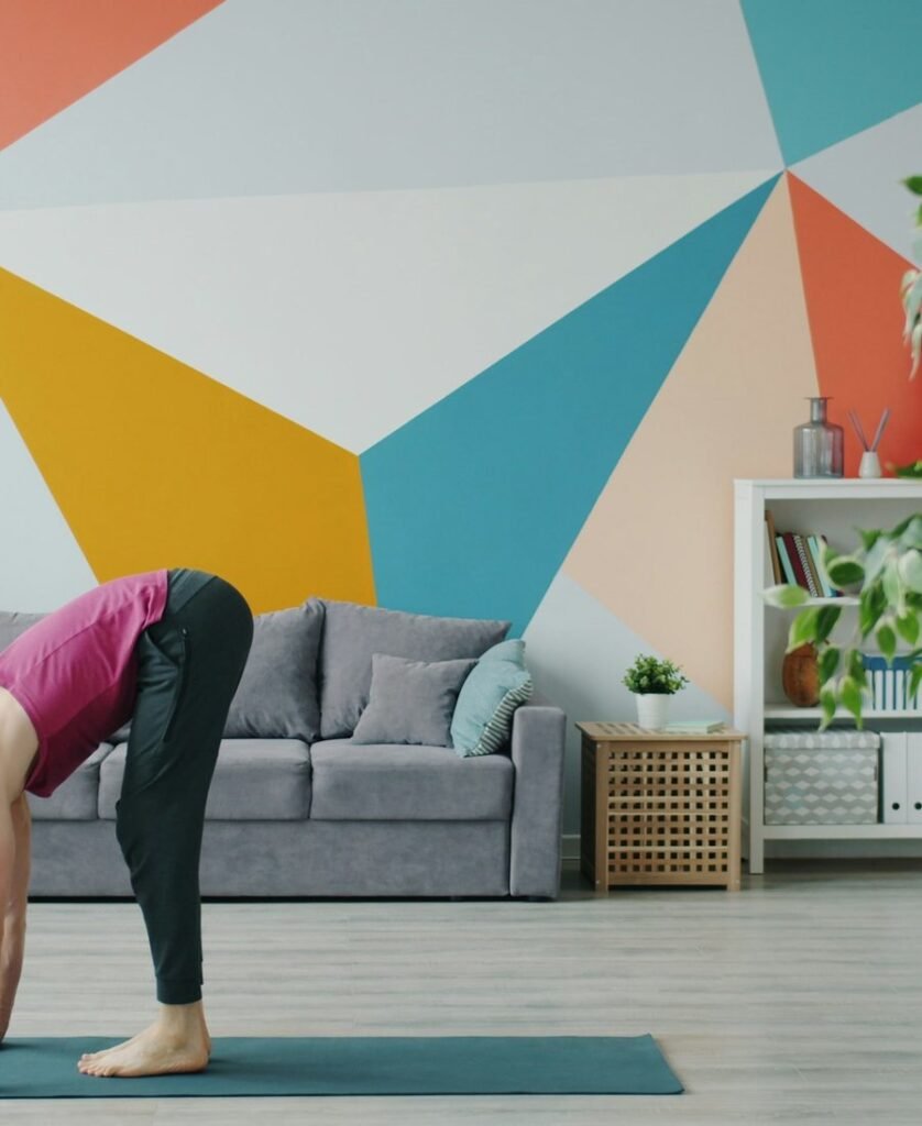 Woman stretching on a yoga mat in a bright room